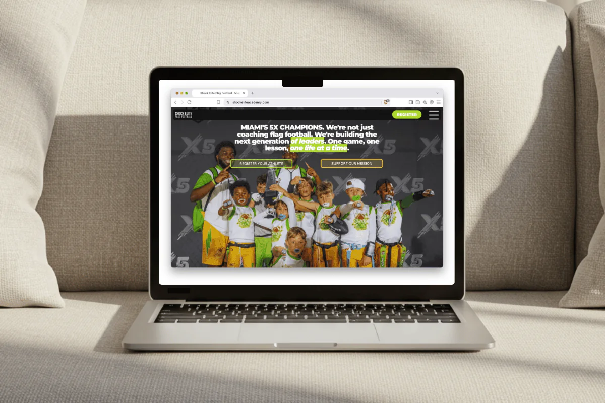 Shock Elite Academy website shown on a laptop